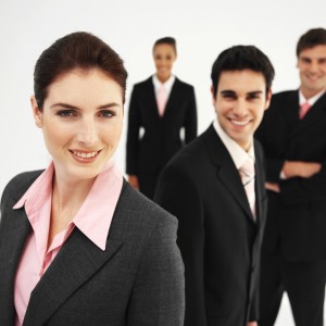 Front view portrait of four business executives smiling